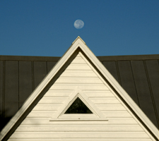Photograph of a Full Moon over a Roof